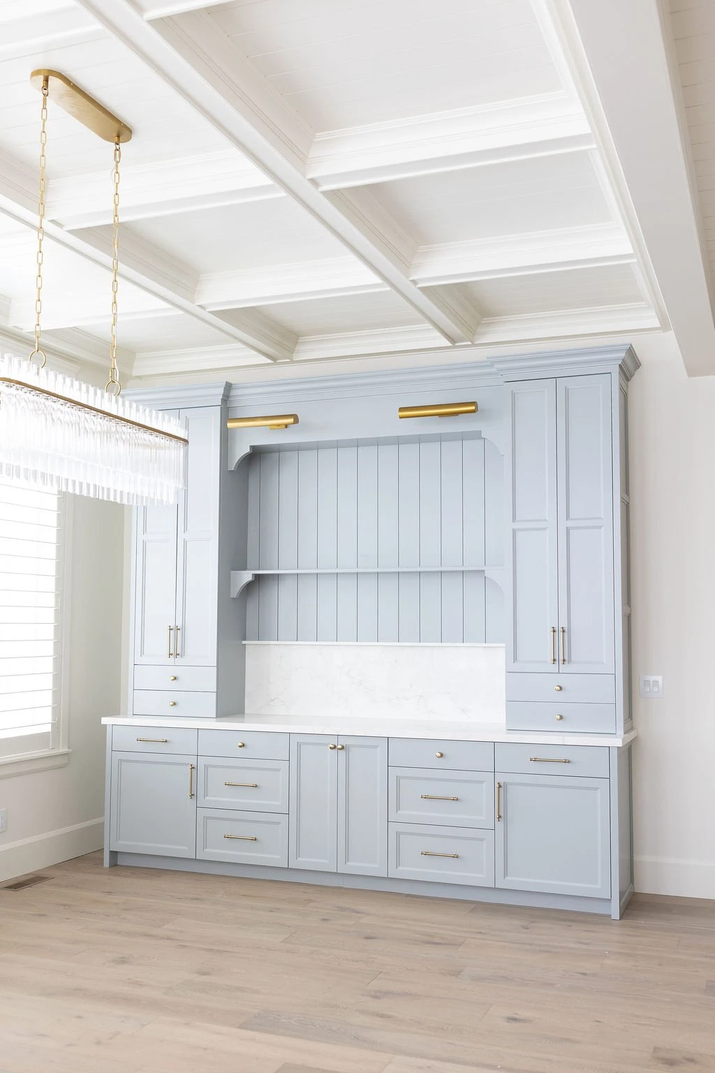Built-in hutch under a coffered ceiling by Warner Cabinets
