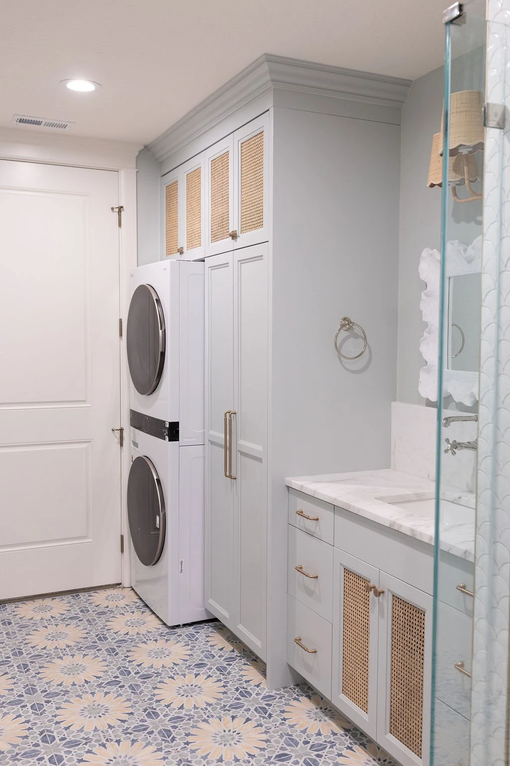 Laundry room with cane-front custom cabinet doors by Warner Cabinets