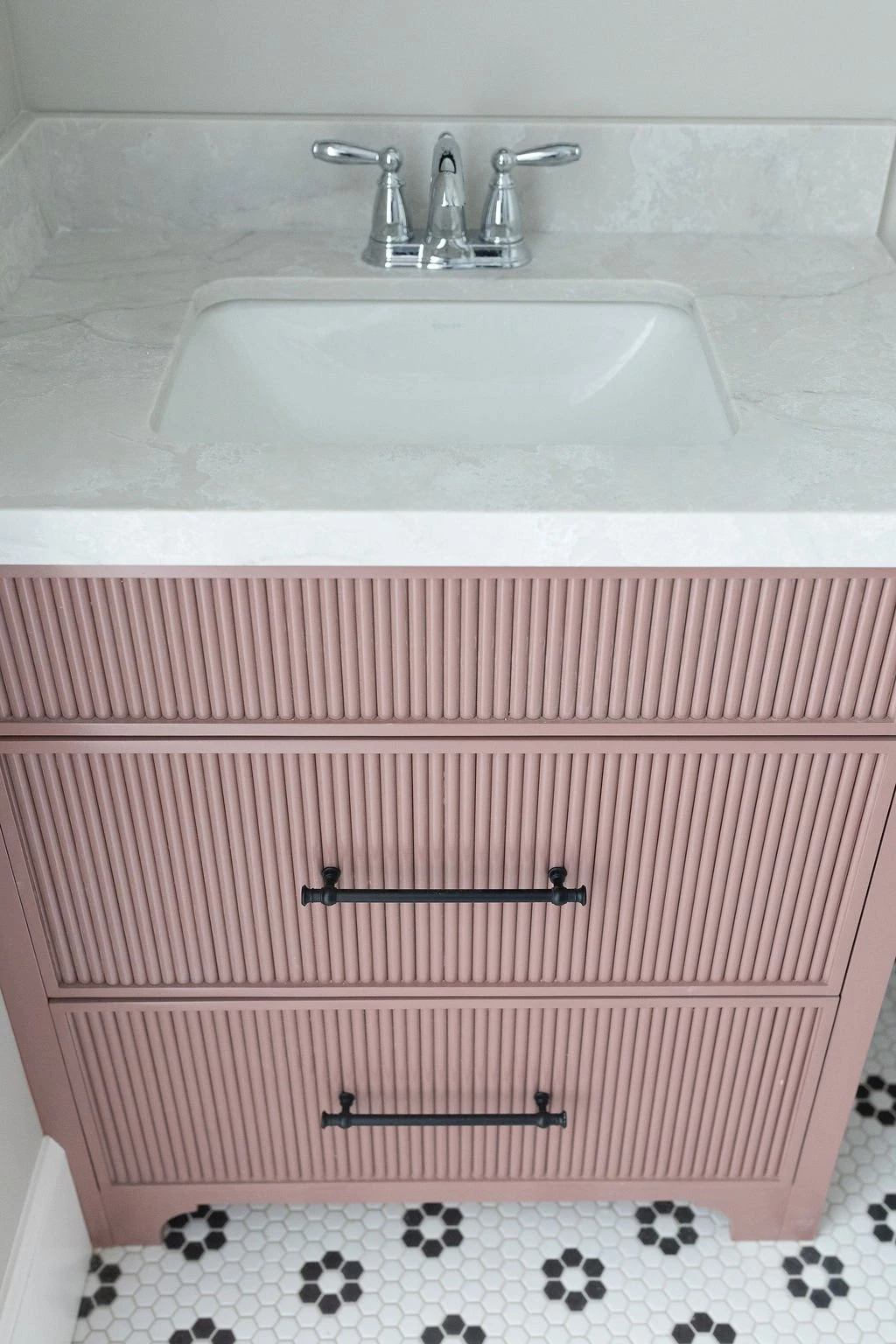 Pink fluted custom vanity by Warner Cabinets